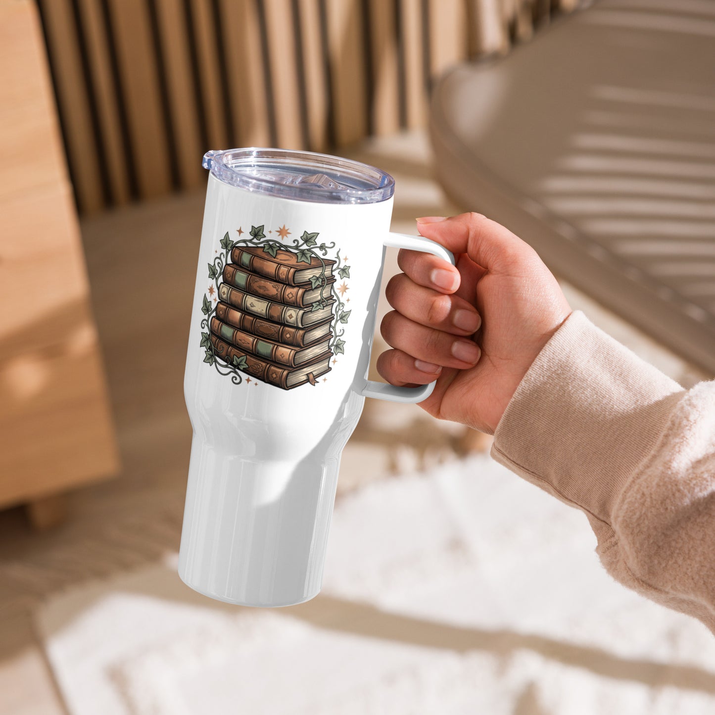 Stacked books and ivy design on a white 25 oz insulated travel mug with a handle, left view
