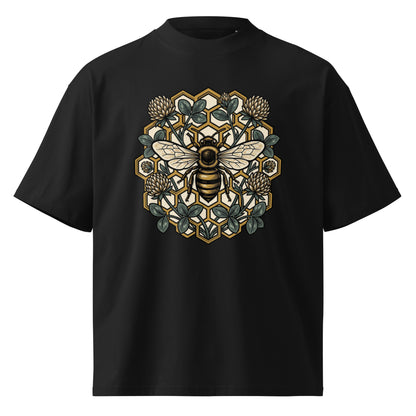 Geometric honeycomb and bee design in teal and gold on a black oversized high-neck tee, front view