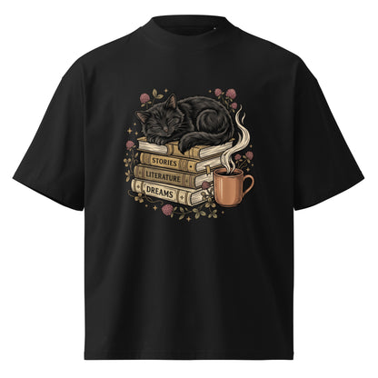 Black cat asleep on a stack of books with coffee and roses, on a black oversized high-neck tee, front view
