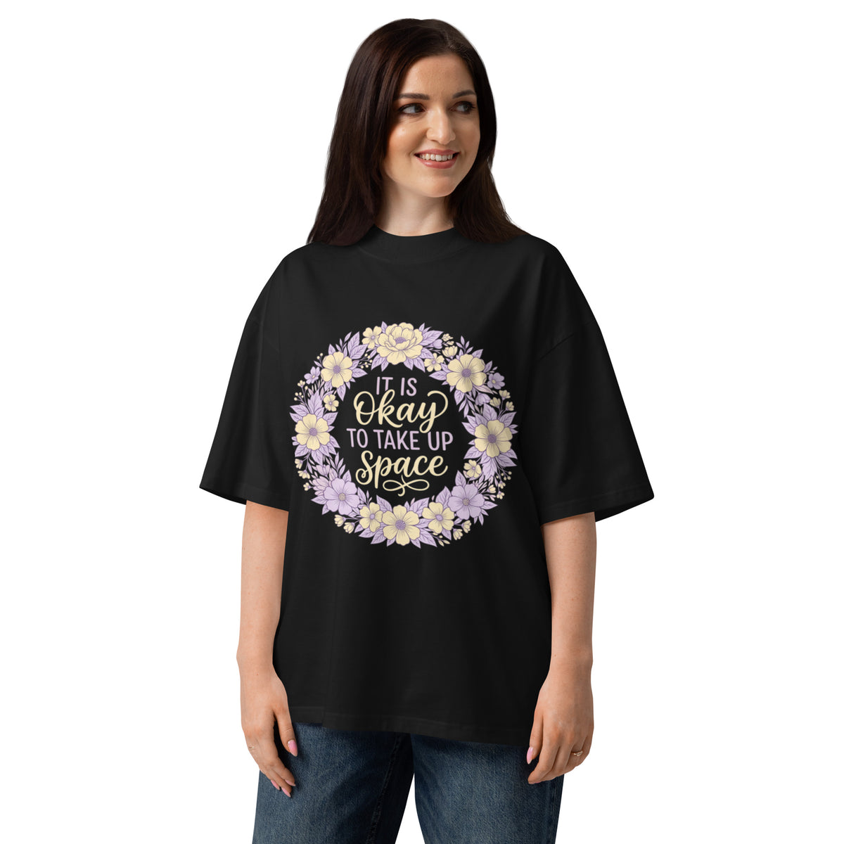 It Is Okay To Take Up Space in a pastel wildflower wreath on a black oversized high-neck tee, front view