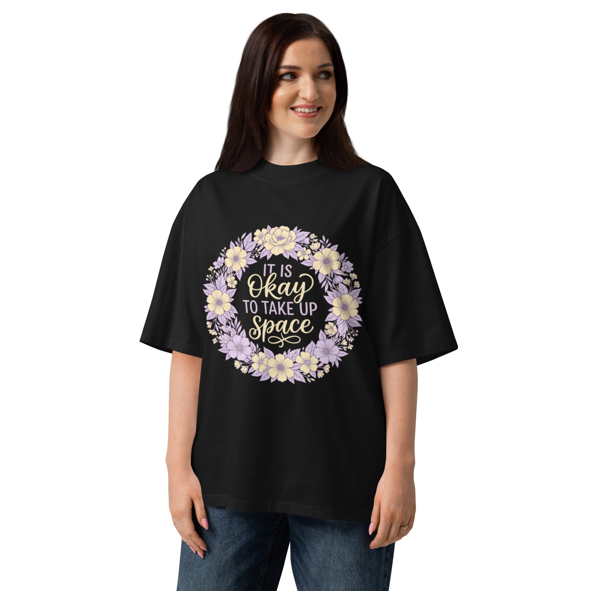 It Is Okay To Take Up Space in a pastel wildflower wreath on a black oversized high-neck tee, front view