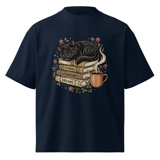 Black cat asleep on a stack of books with coffee and roses, on a French Navy oversized high-neck tee, front view