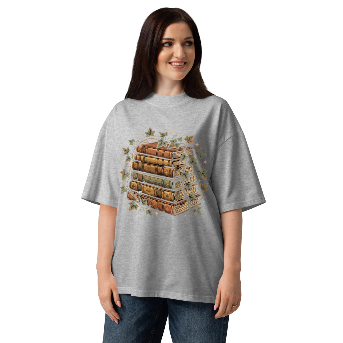 Stack of vintage books wound with ivy on a heather grey oversized high-neck tee, front view
