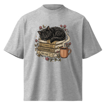 Black cat asleep on a stack of books with coffee and roses, on a heather grey oversized high-neck tee, front view