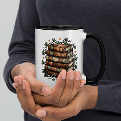 Stacked books and ivy design on a white ceramic mug with black rim and handle, 15 oz, right view