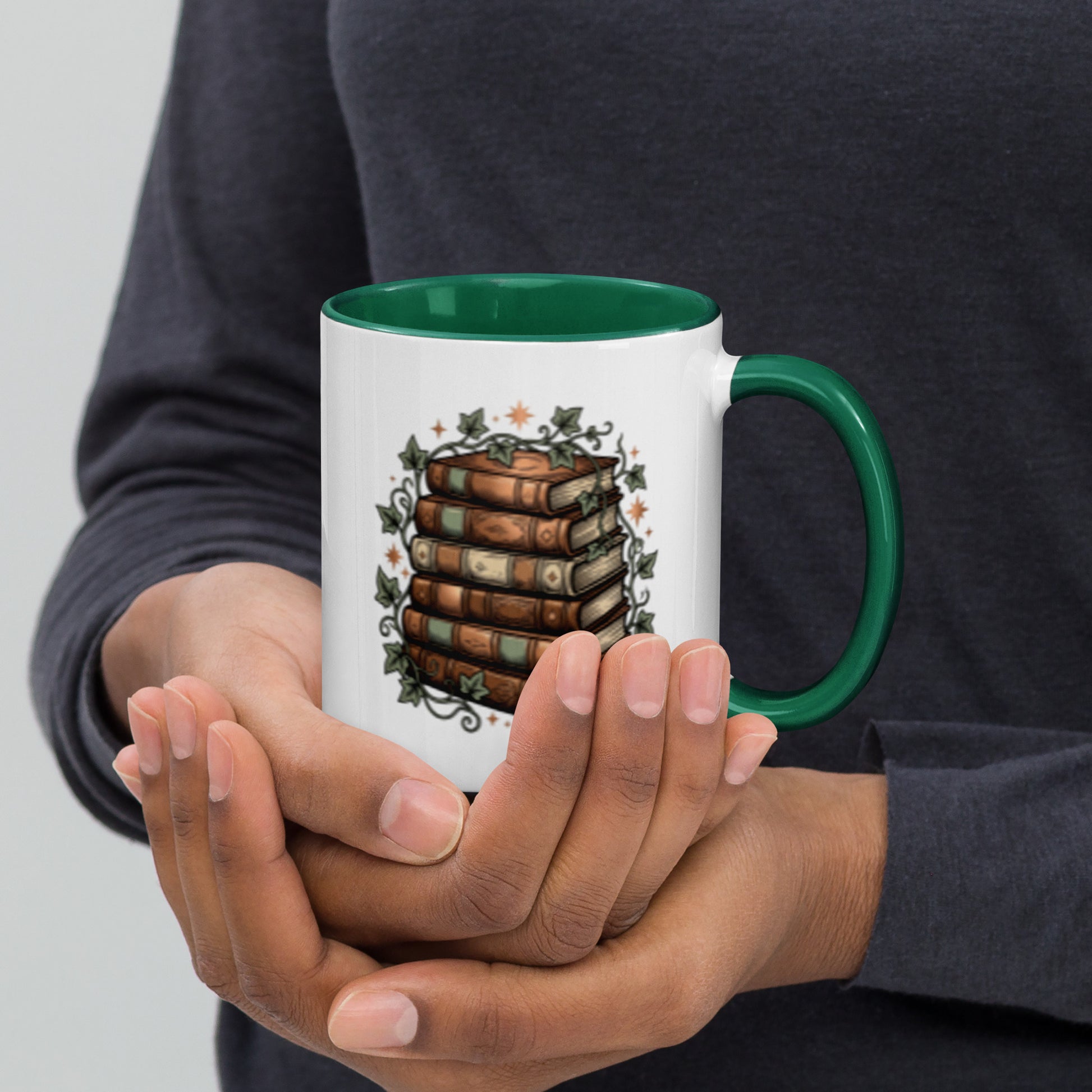 Stacked books and ivy design on a white ceramic mug with dark green rim and handle, 11 oz, right view
