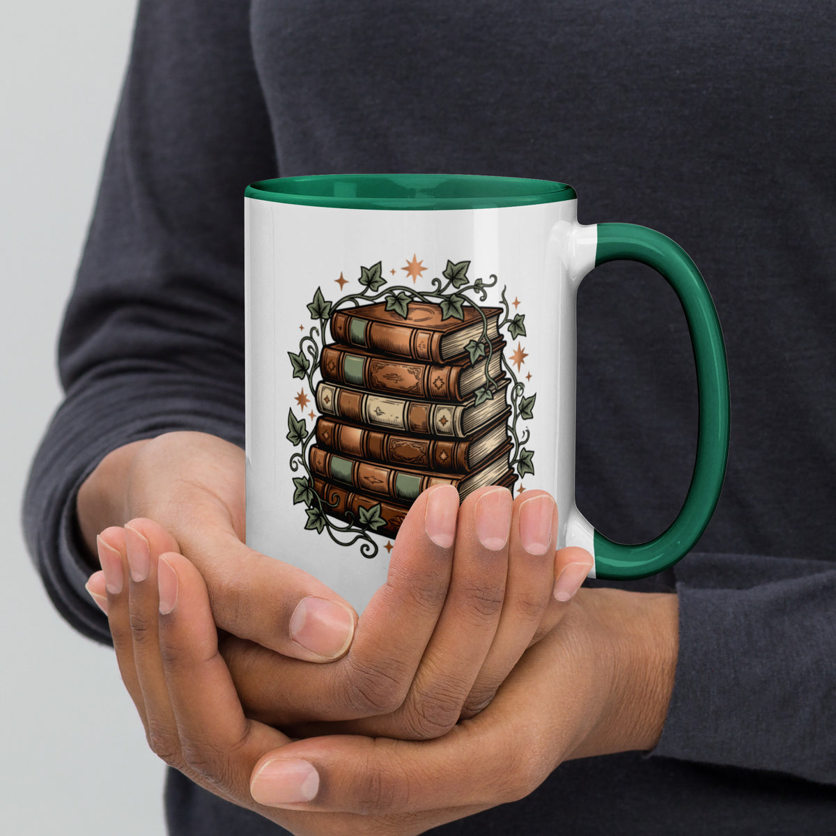 Stacked books and ivy design on a white ceramic mug with dark green rim and handle, 15 oz, right view
