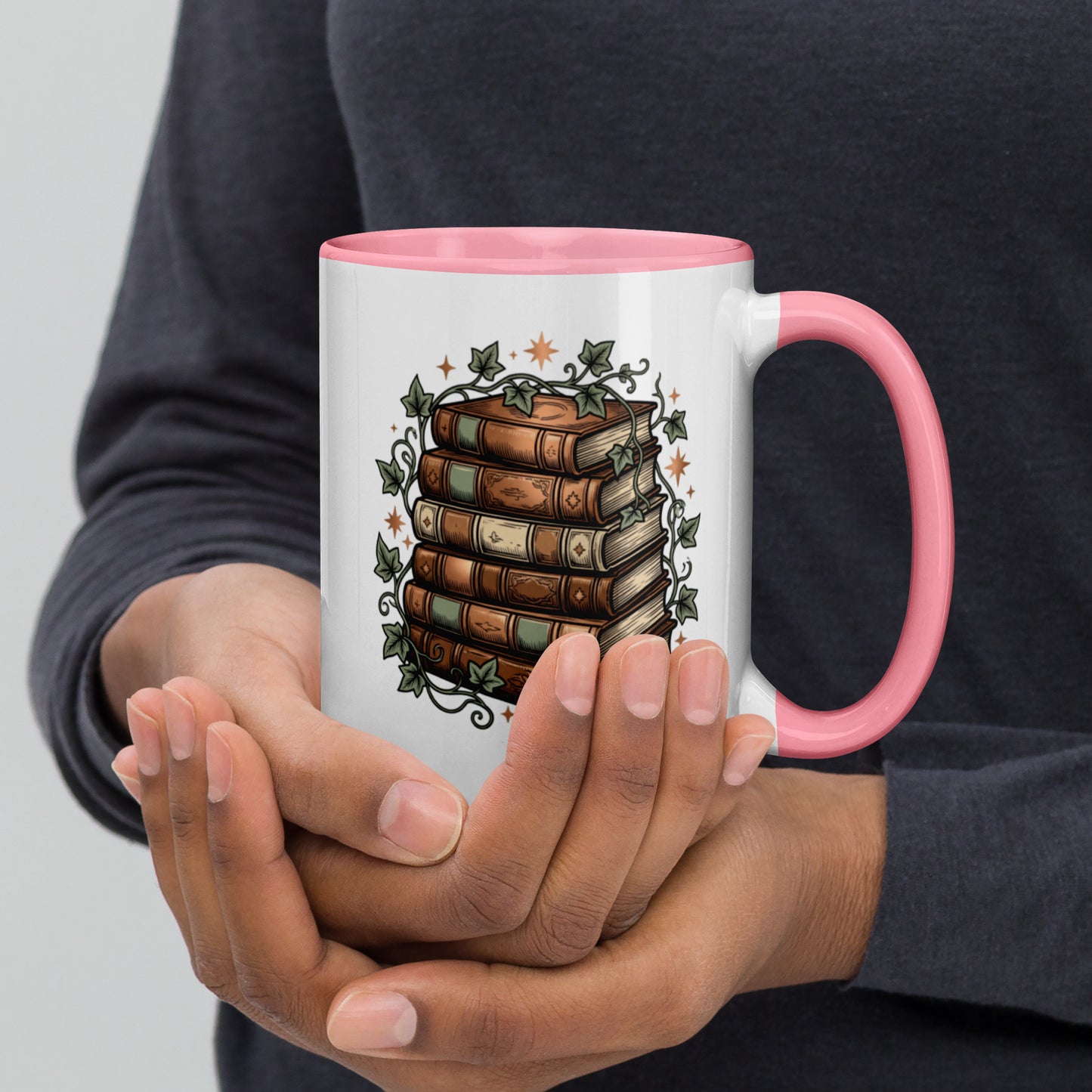 Stacked books and ivy design on a white ceramic mug with pink rim and handle, 15 oz, right view