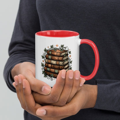 Stacked books and ivy design on a white ceramic mug with red rim and handle, 11 oz, right view