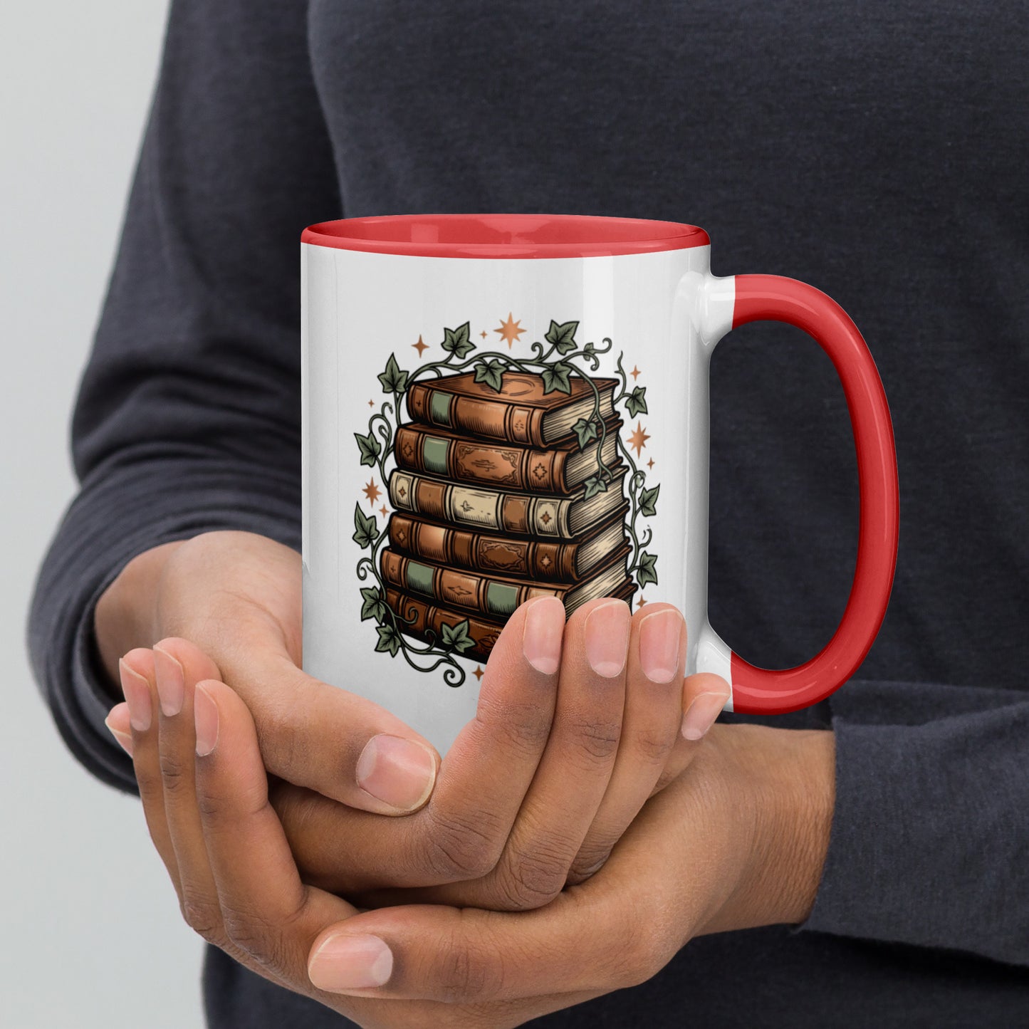 Stacked books and ivy design on a white ceramic mug with red rim and handle, 15 oz, right view