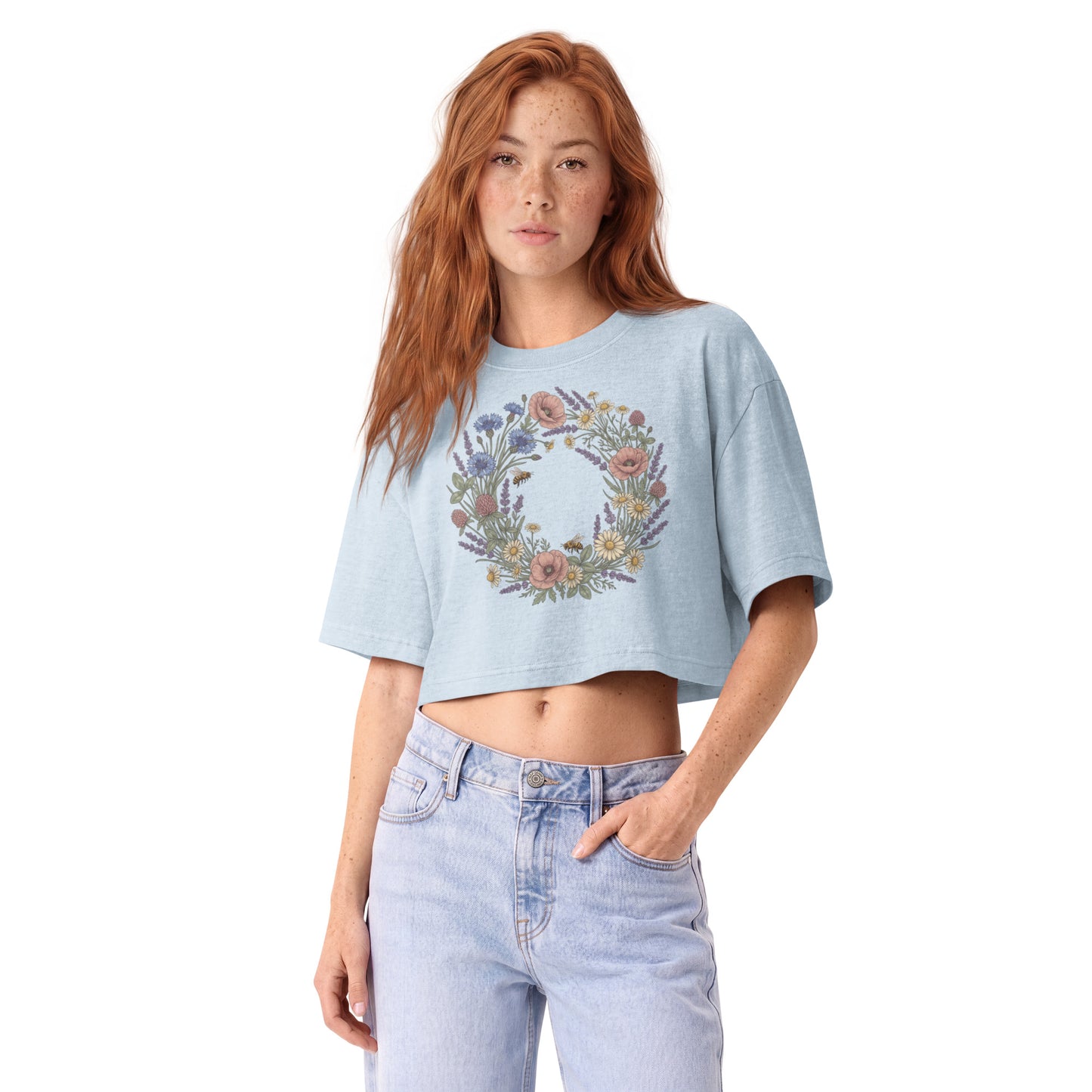 Pastel wildflower wreath printed on a light washed denim garment-dyed cropped tee, front view