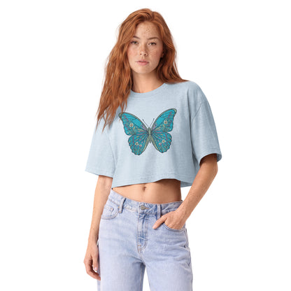 Detailed teal morpho butterfly printed on a light washed denim garment-dyed cropped tee, front view