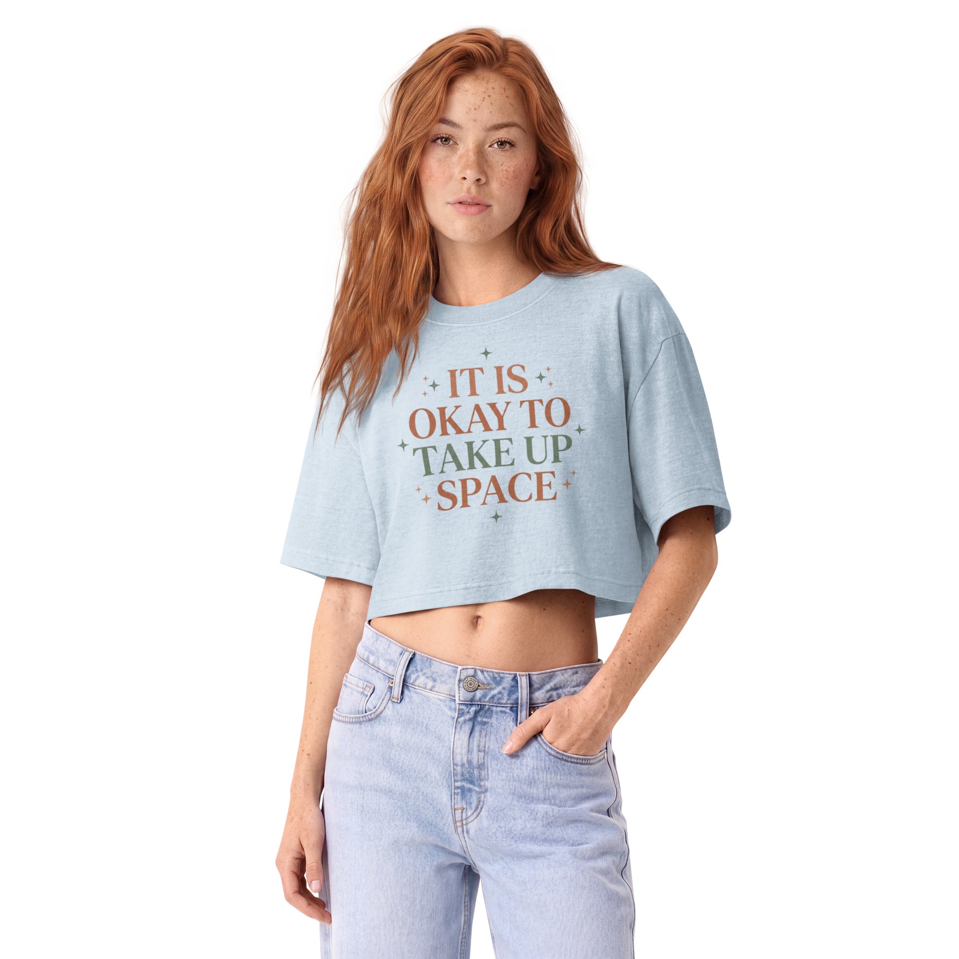 It Is Okay To Take Up Space in celestial serif lettering on a light washed denim garment-dyed cropped tee, front view