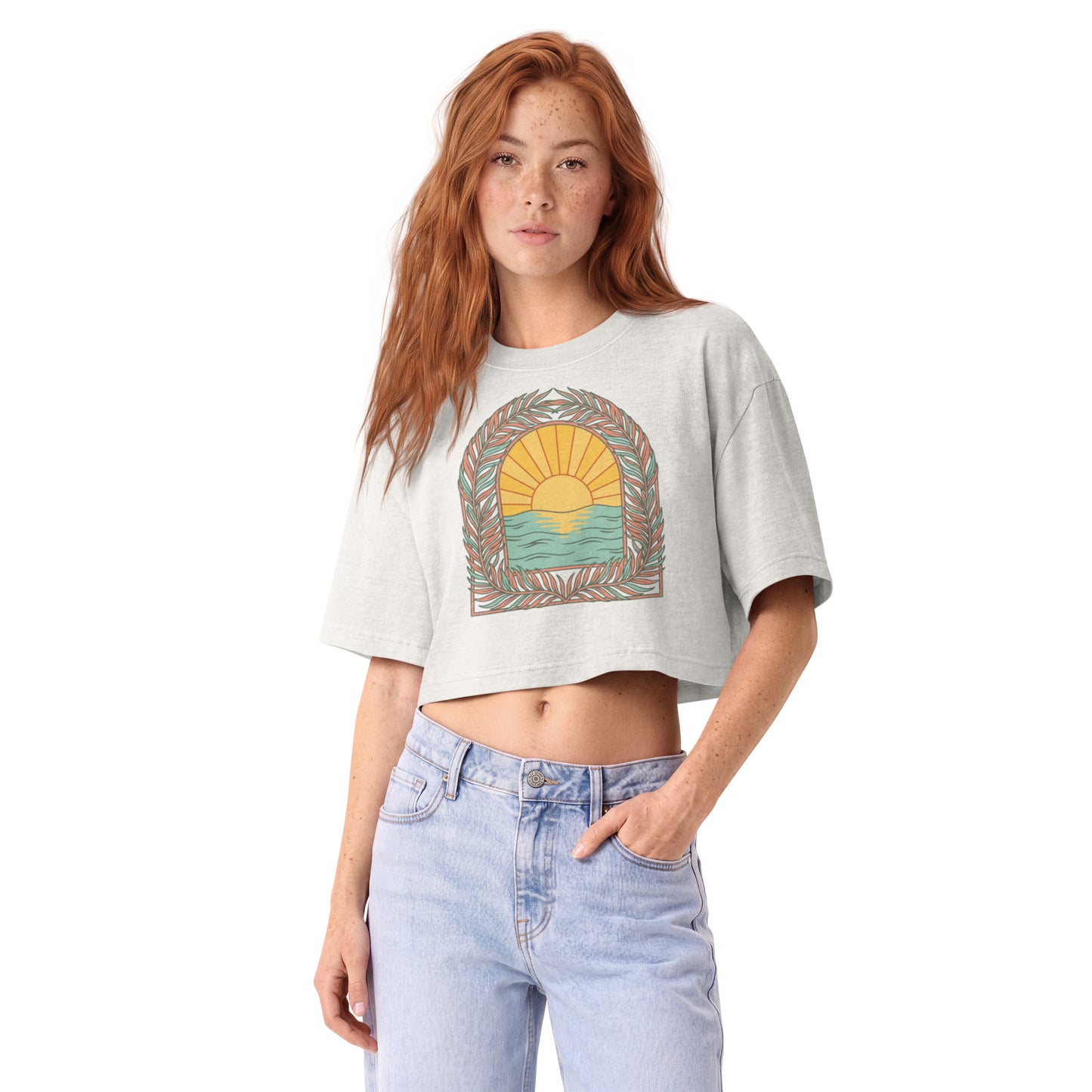 Retro sunrise and ocean arch framed in botanicals on a vintage white garment-dyed cropped tee, front view