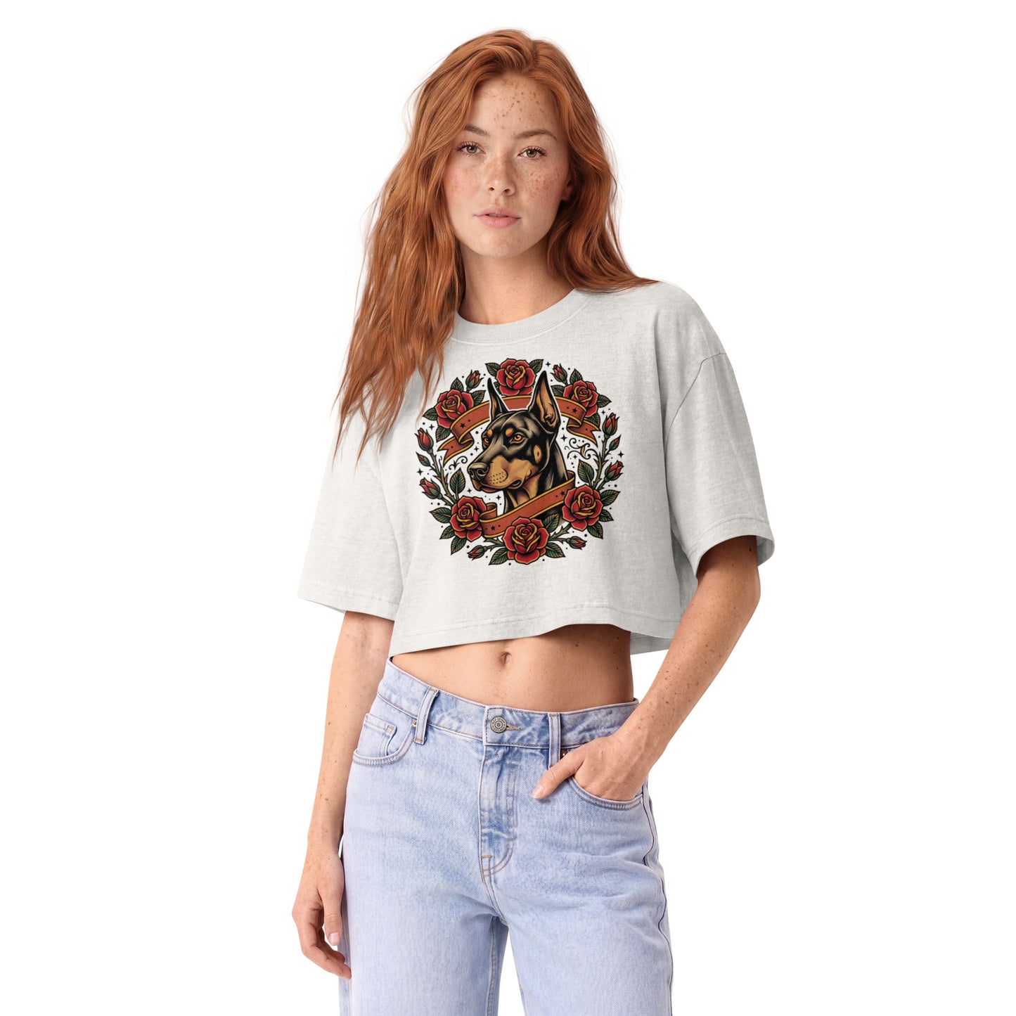 Tattoo-style Doberman framed in red roses on a vintage white garment-dyed cropped tee, front view