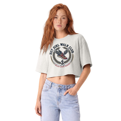 Hot Girl Walk Club varsity crest with a winged trainer on a vintage white garment-dyed cropped tee, front view
