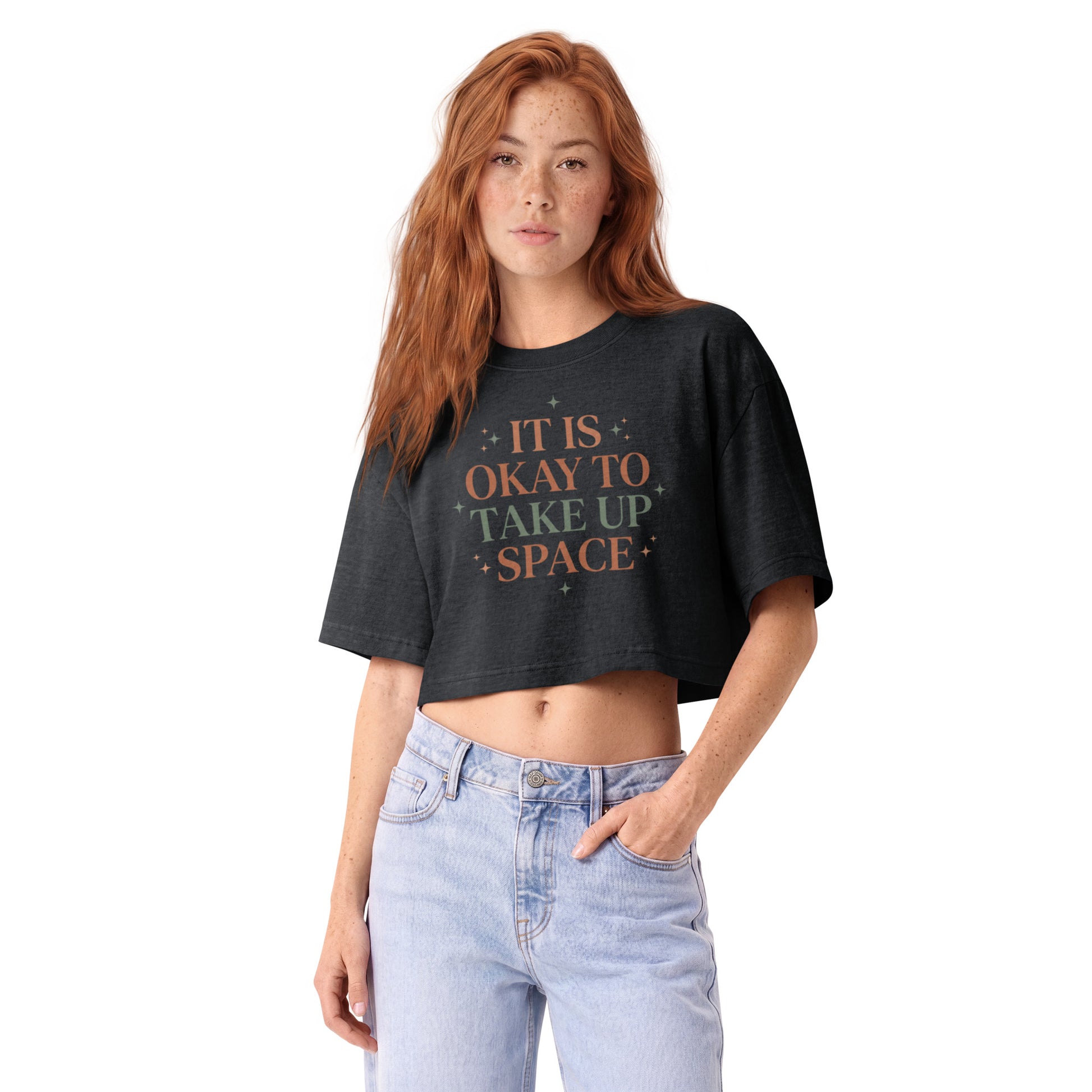 It Is Okay To Take Up Space in celestial serif lettering on a washed black garment-dyed cropped tee, front view